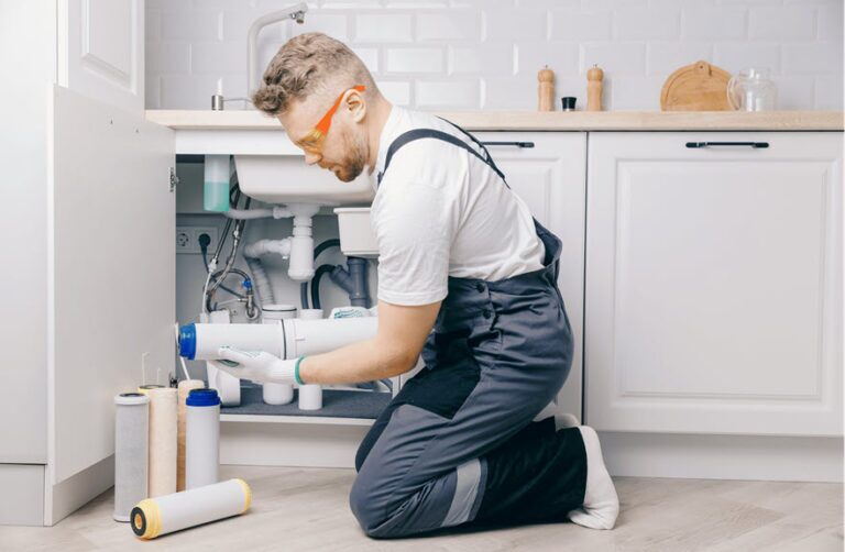 A technician installs a home water filter for filtration of microplastics.